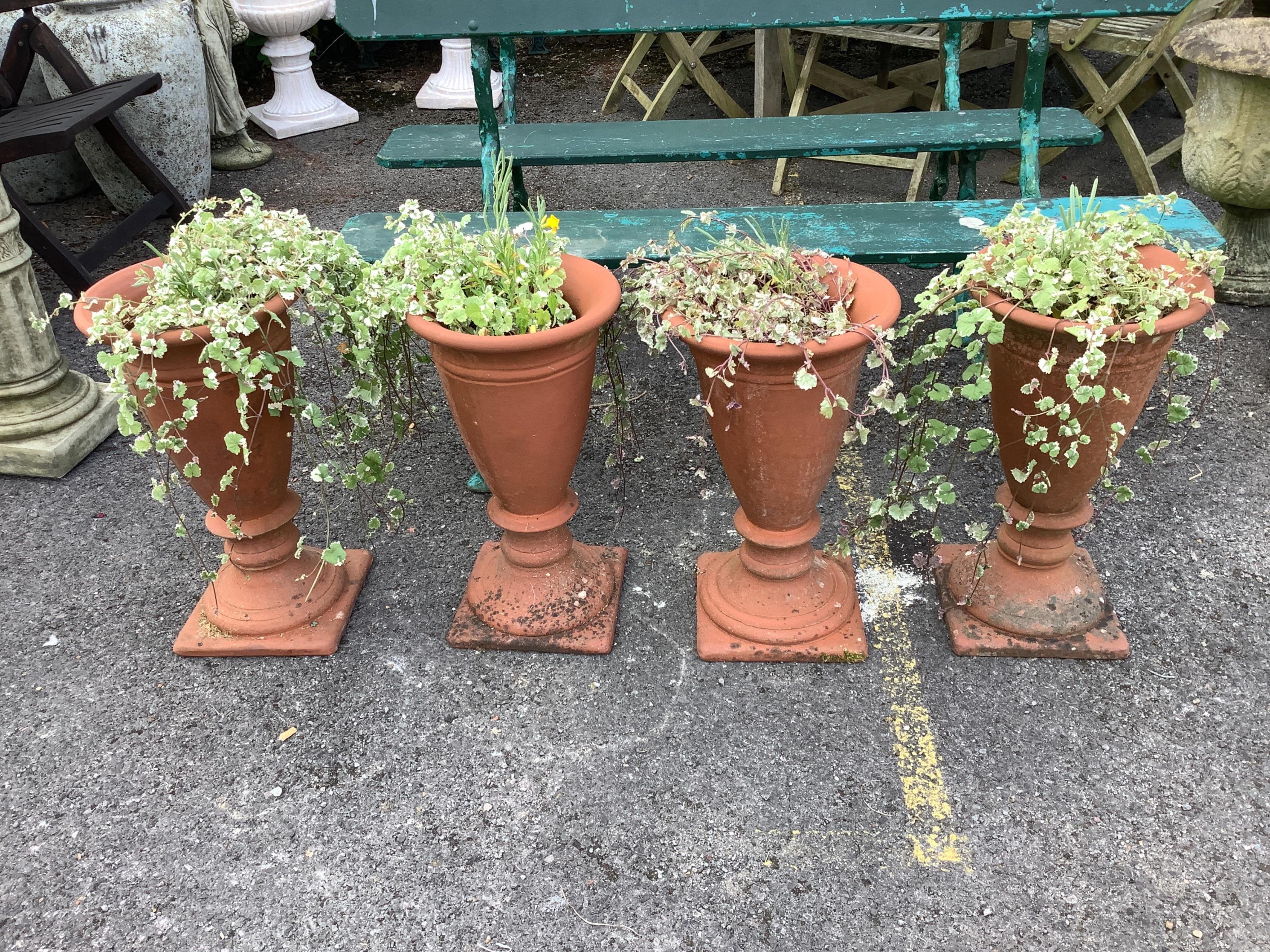 A set of four conical terracotta garden planters, diameter 31cm, height 53cm. Condition - good